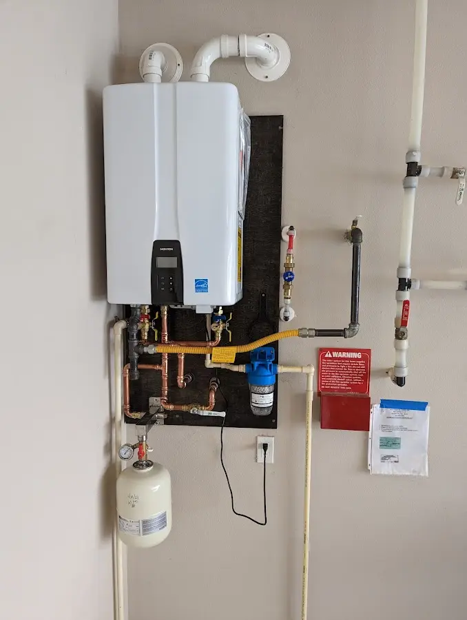 Professional plumber installing copper piping in a Owasco home